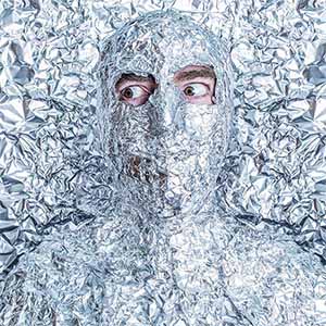 man covered in tin foil with eyes visible